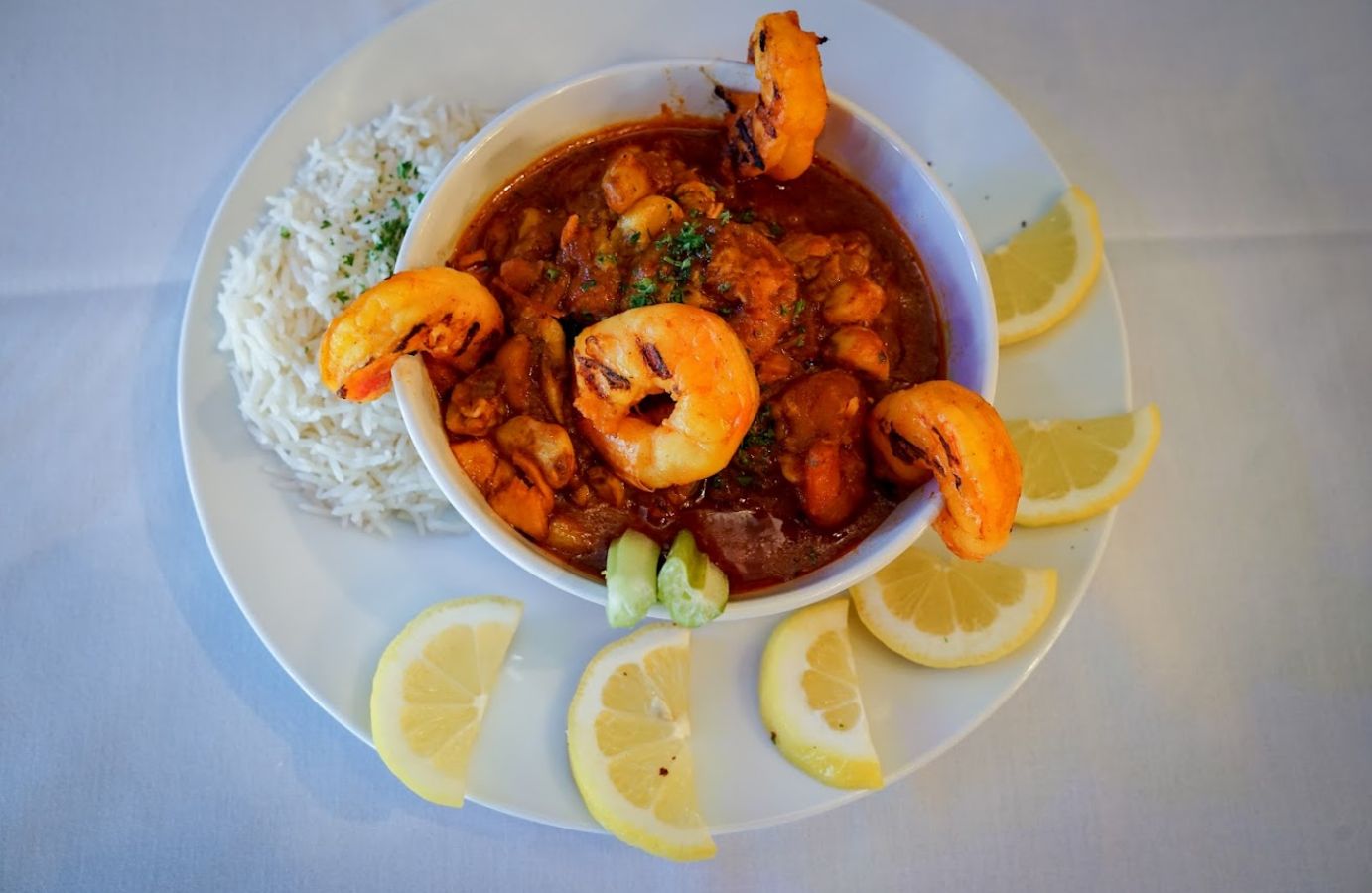shrimp stew with rice and lemon on a plate