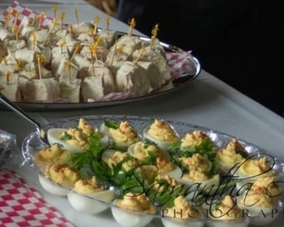 deviled eggs on a tray with a knife and fork.