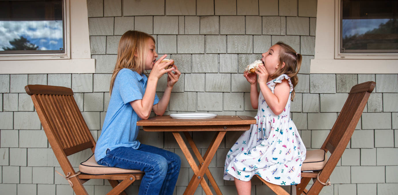 Children eating pastries in patio area