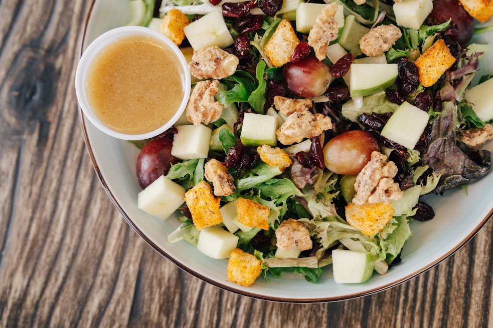 Salad with mixed greens, apples, walnuts, grapes, cranberries, croutons and dressing