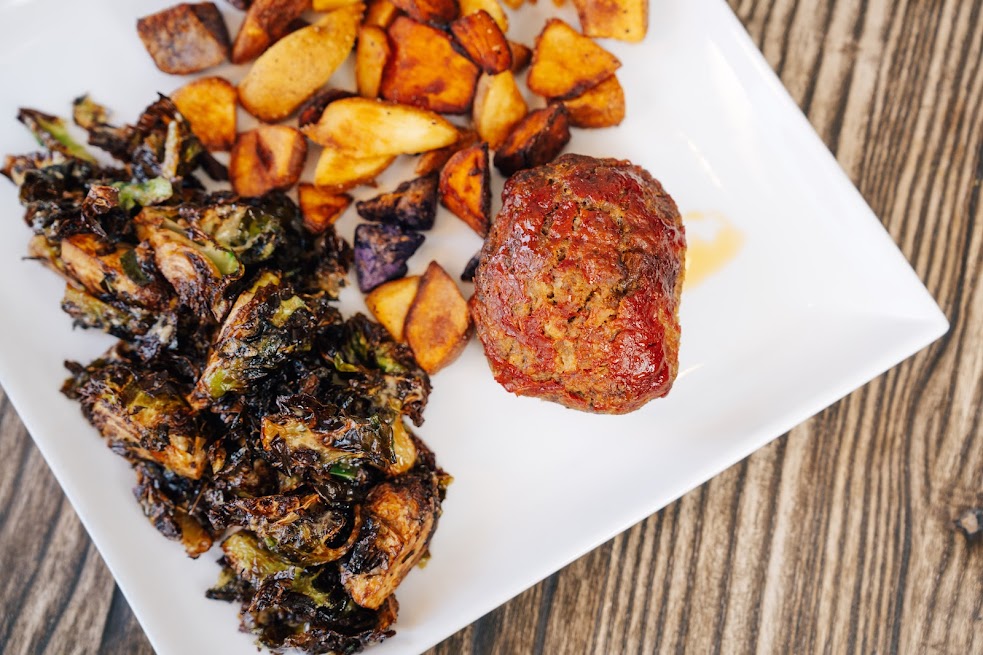 Meatloaf in tomato glaze, with baked potatoes and grilled Brussels sprouts