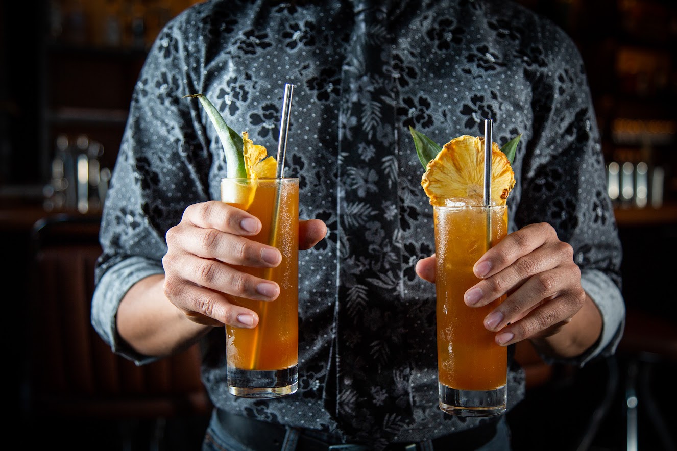 Bartender holding two cocktails