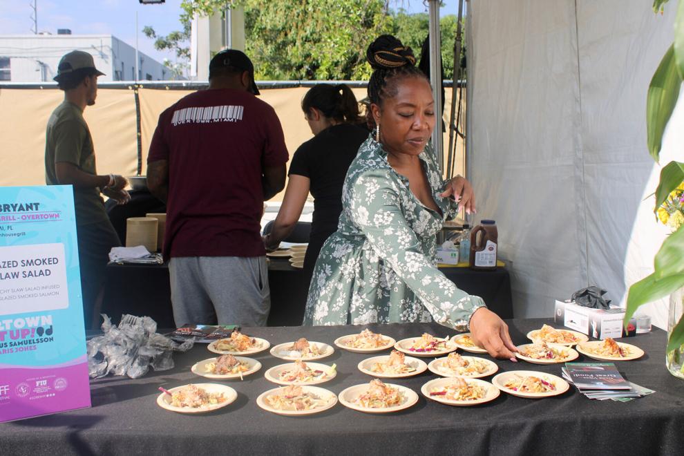 Nicole Gates, co-owner, serves up smoked salmon slaw salads at the Overtown Eatup
