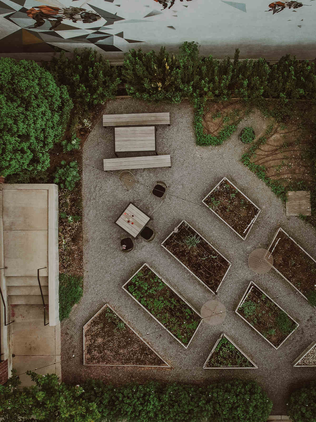 an aerial view of a garden with benches.