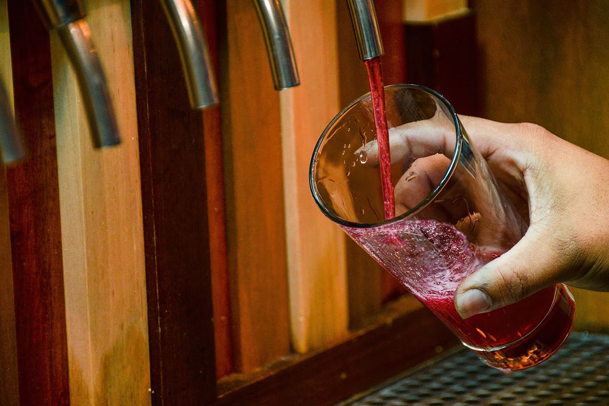 The bartender is pouring beer