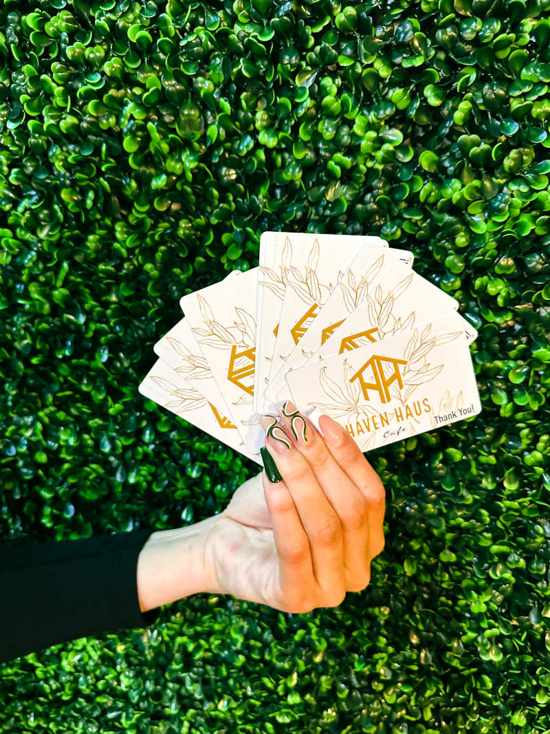 A hand holding gift cards