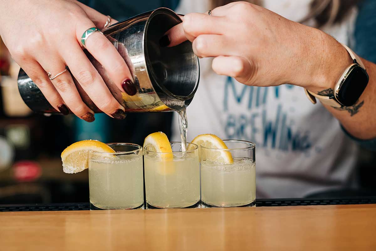 Pouring Lemon Drop shots from a shaker