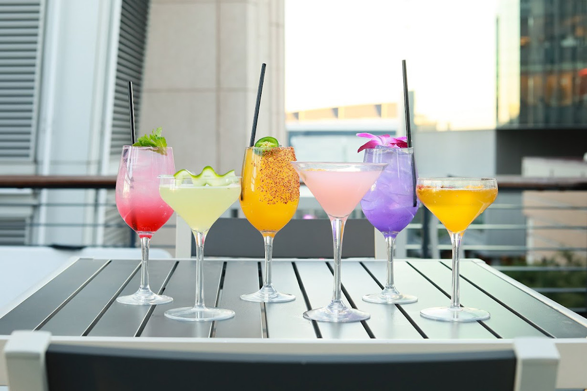 Assorted cocktail drinks served on the table outside.