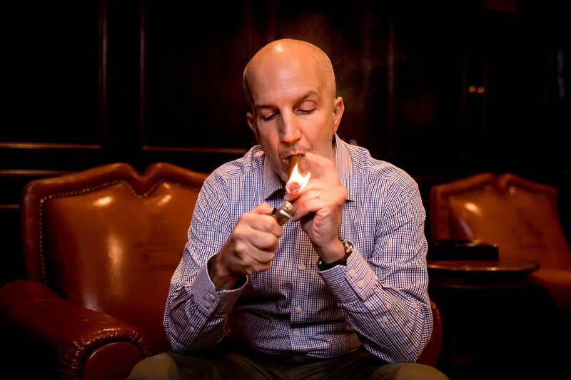 A man lights a cigar