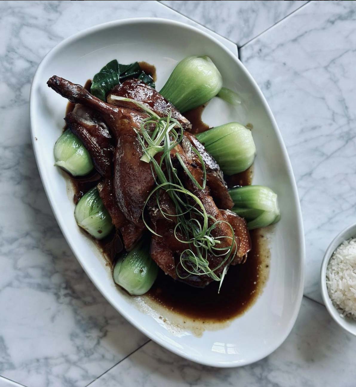 Half duck, served with baby bok choy 