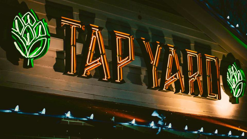 Tap Yard logo on a wooden board