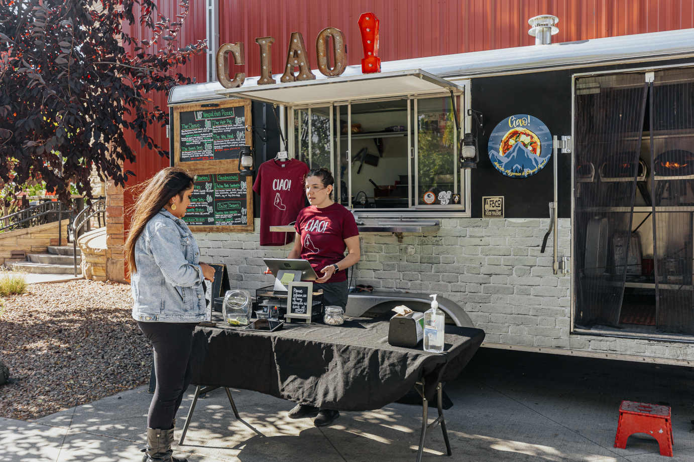 Employee and customer in front of food truck