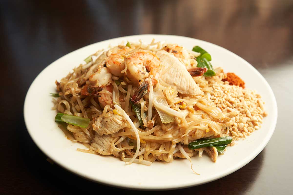 Chicken and shrimp noodles, with peanuts and ground peppers