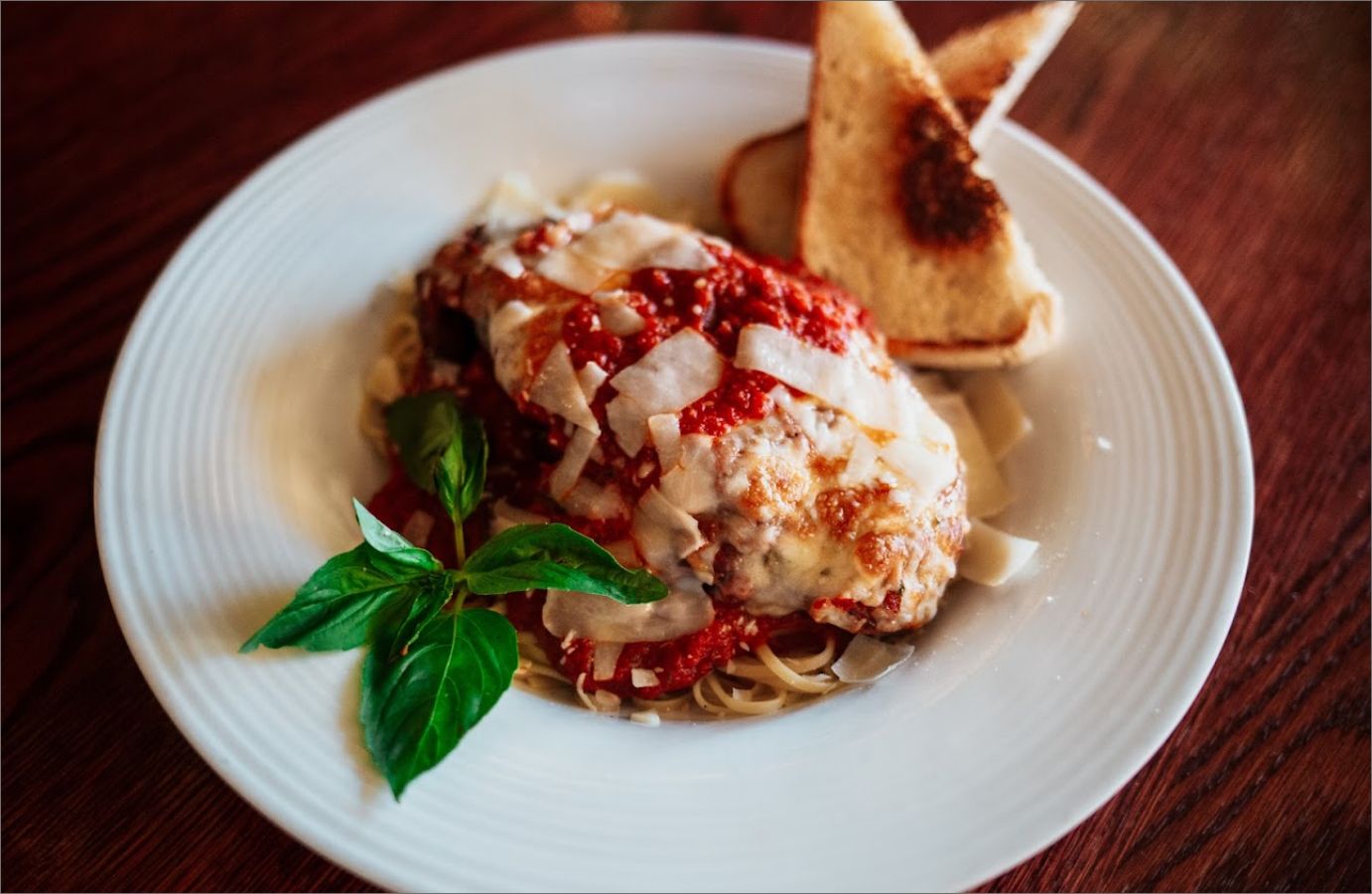 CHICKEN PARM top view on a white plate