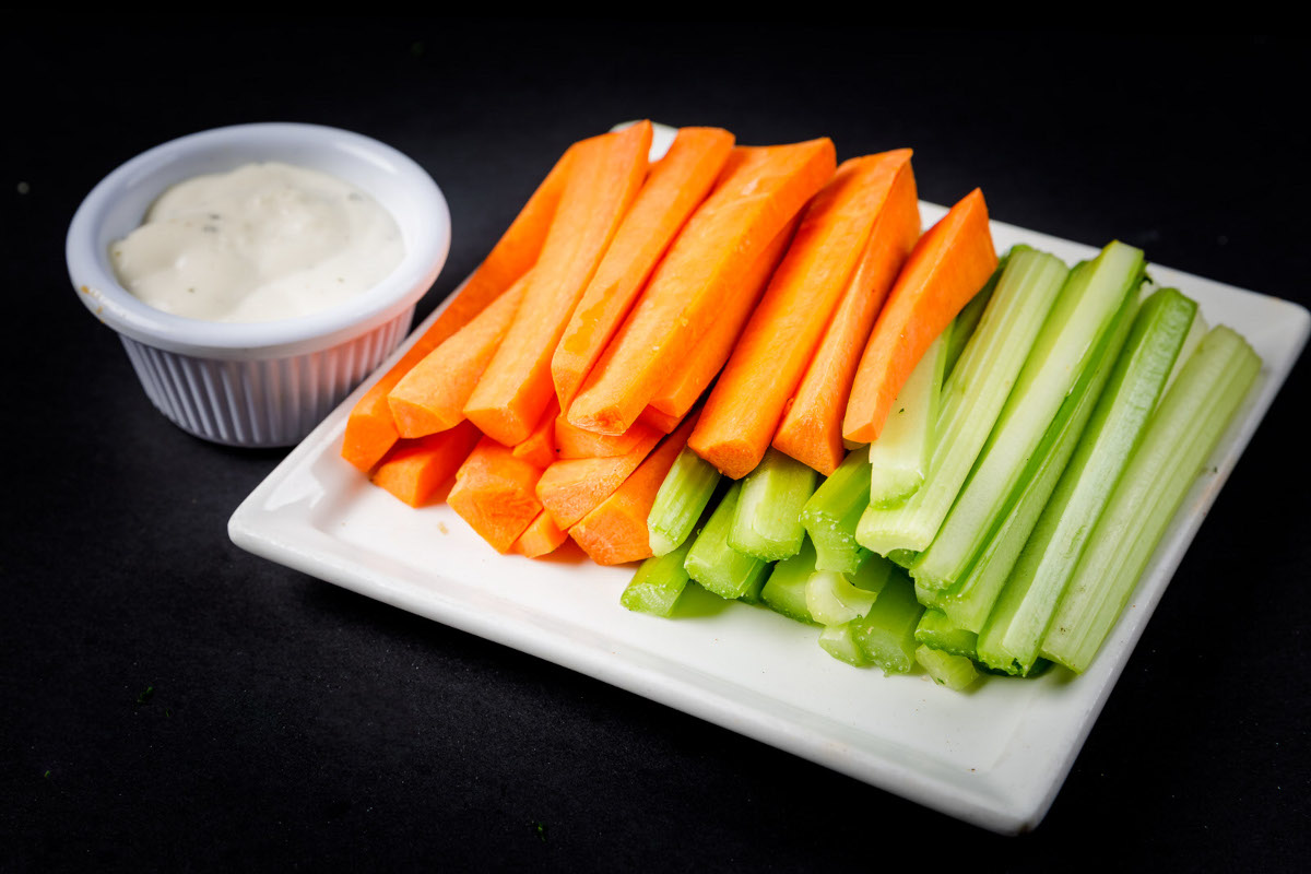 Celery and carrot sticks, with a side of sauce