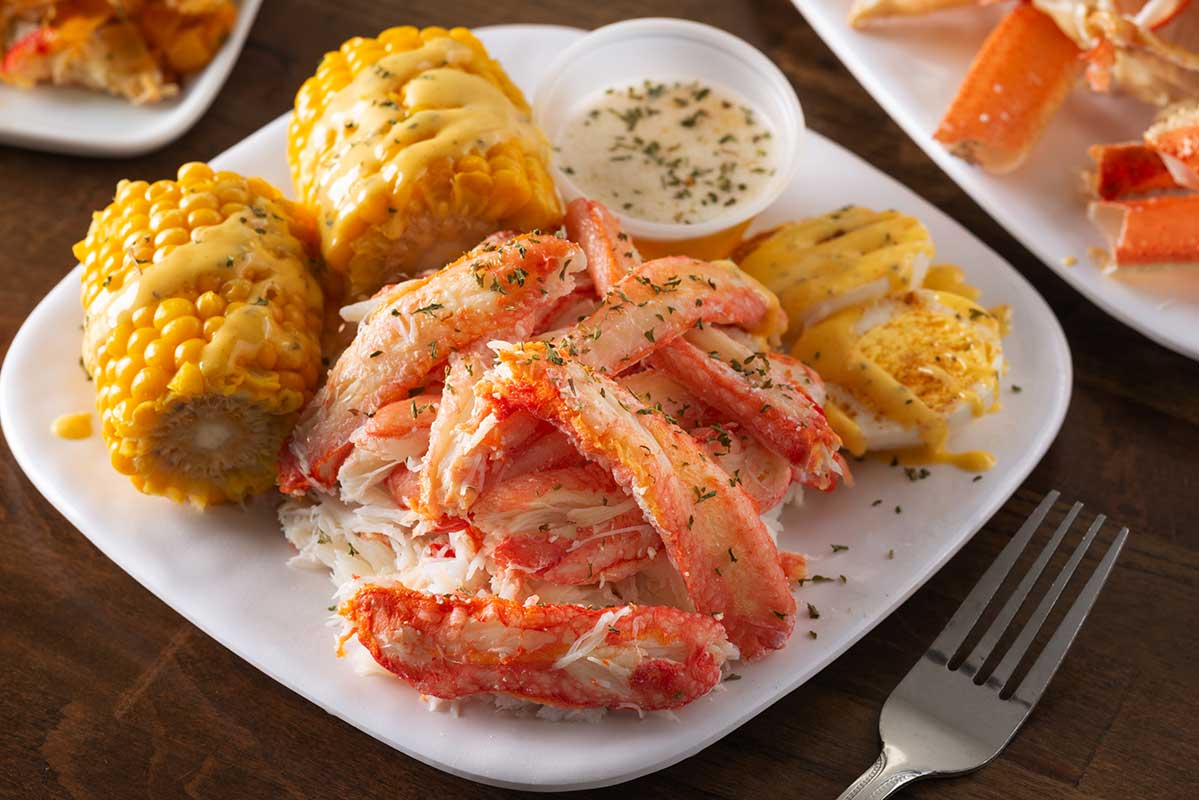 Shelled Crab, served with street corn, boiled egg and a sauce dip