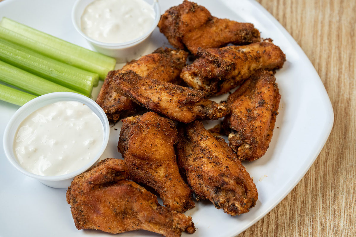 Dry Rub Wings with celery sticks and sauces