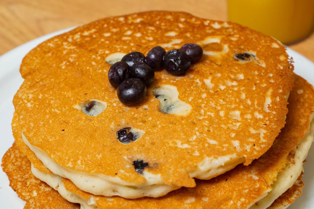 Blueberry Pancakes and a glass of orange juice