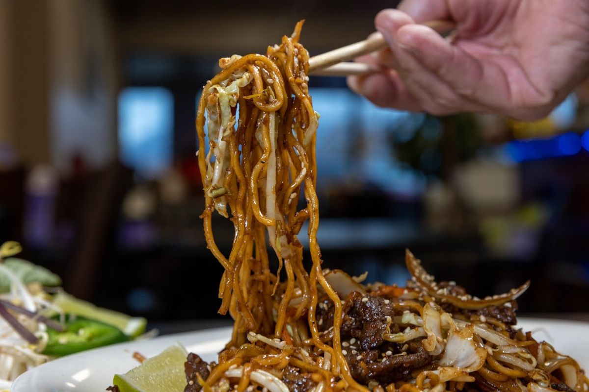  Stir-fried Ramen, shot of noodles eaten with chopsticks