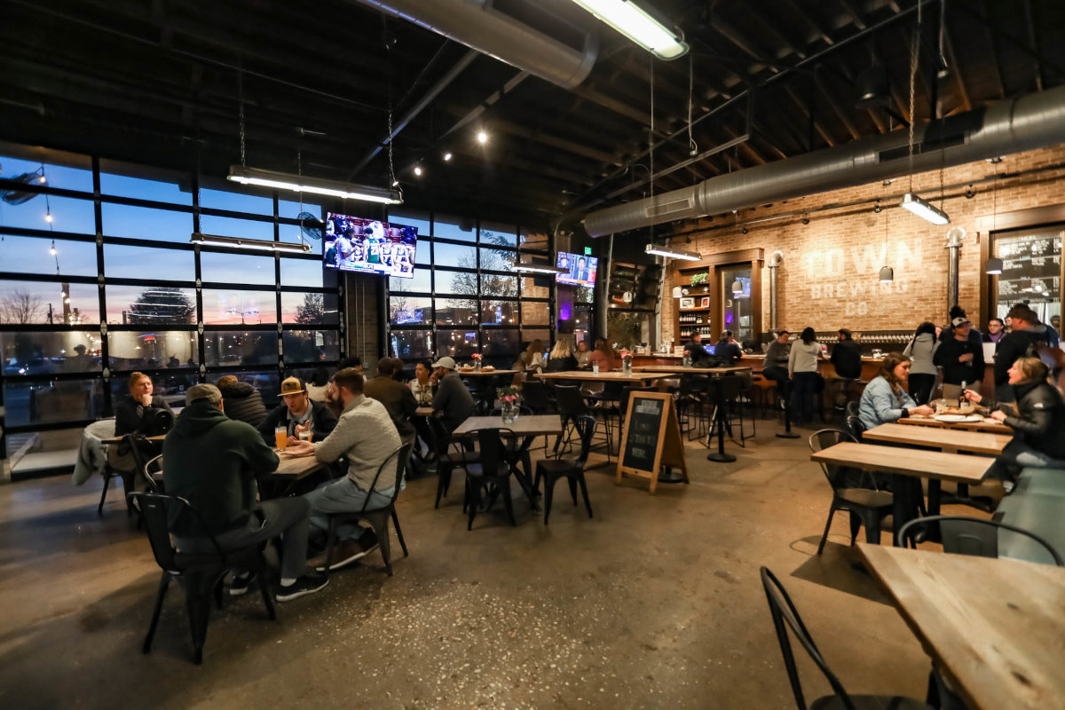 Interior, industrial, wide view, guests enjoying food and drinks