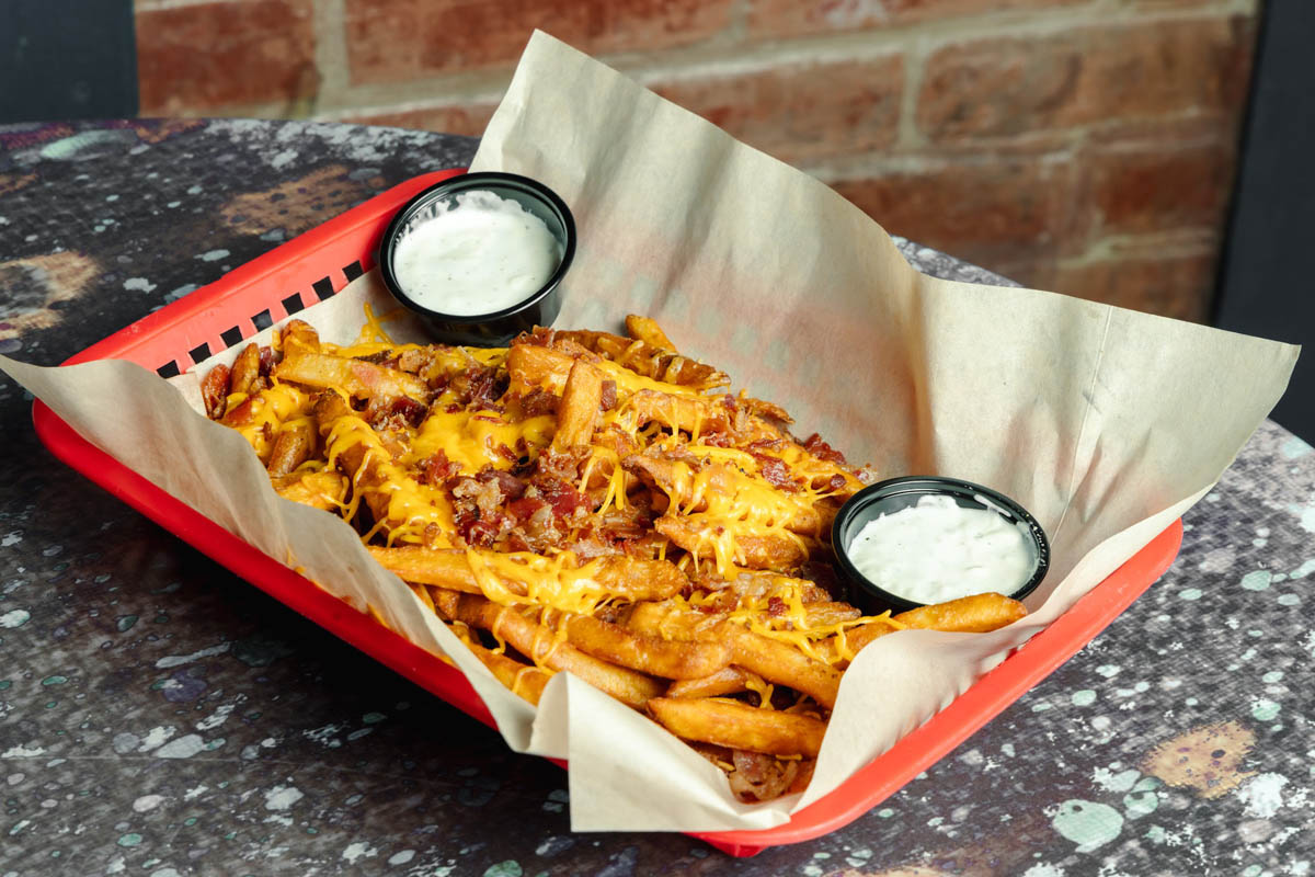Cheese fries with bacon and sauce dips