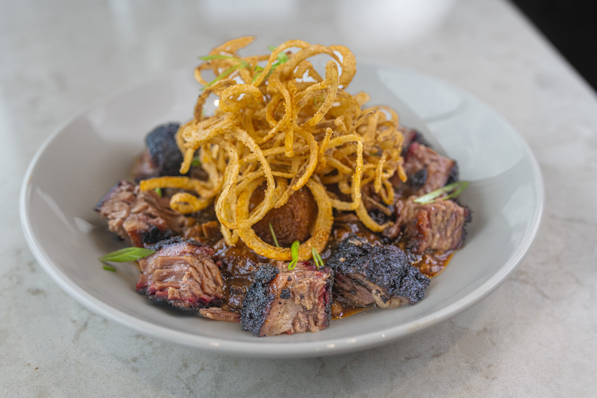 Smoked beef burnt ends, pit beans, cornbread, and onion straws