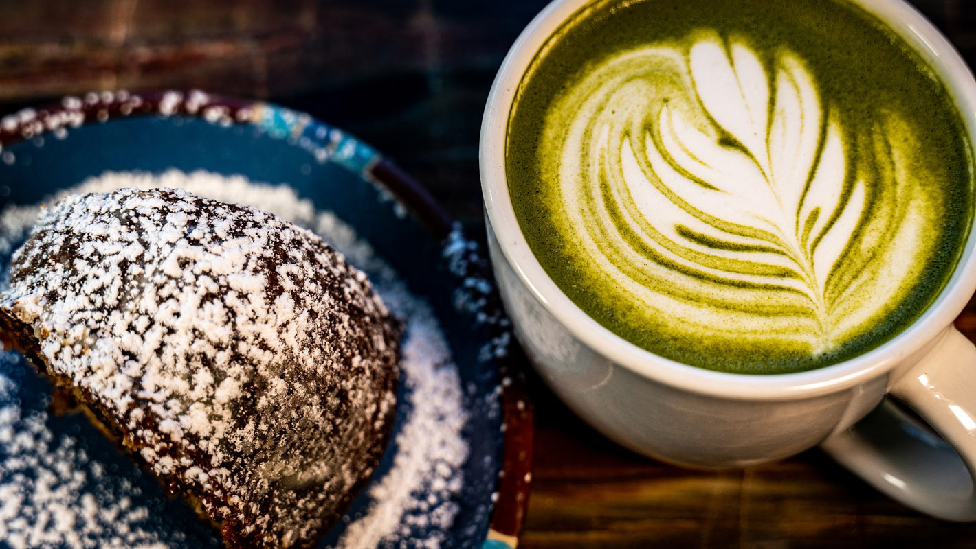 Chocolate dessert served with a cup of Matcha latte