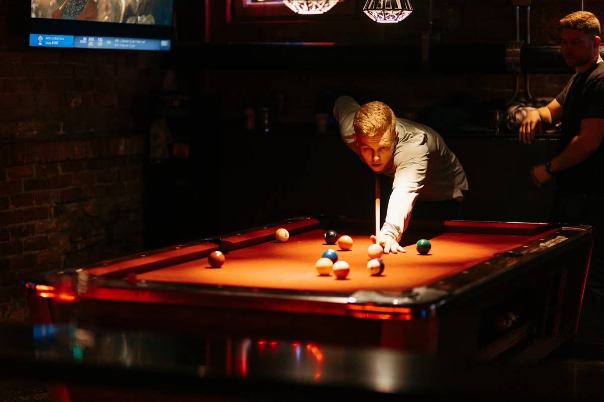 Two people playing pool