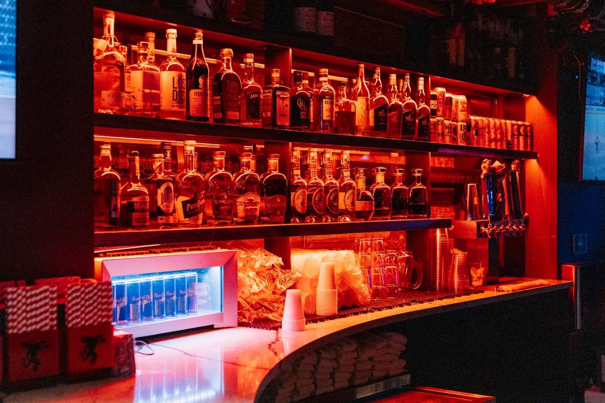 Various liquor bottles on a bar shelf