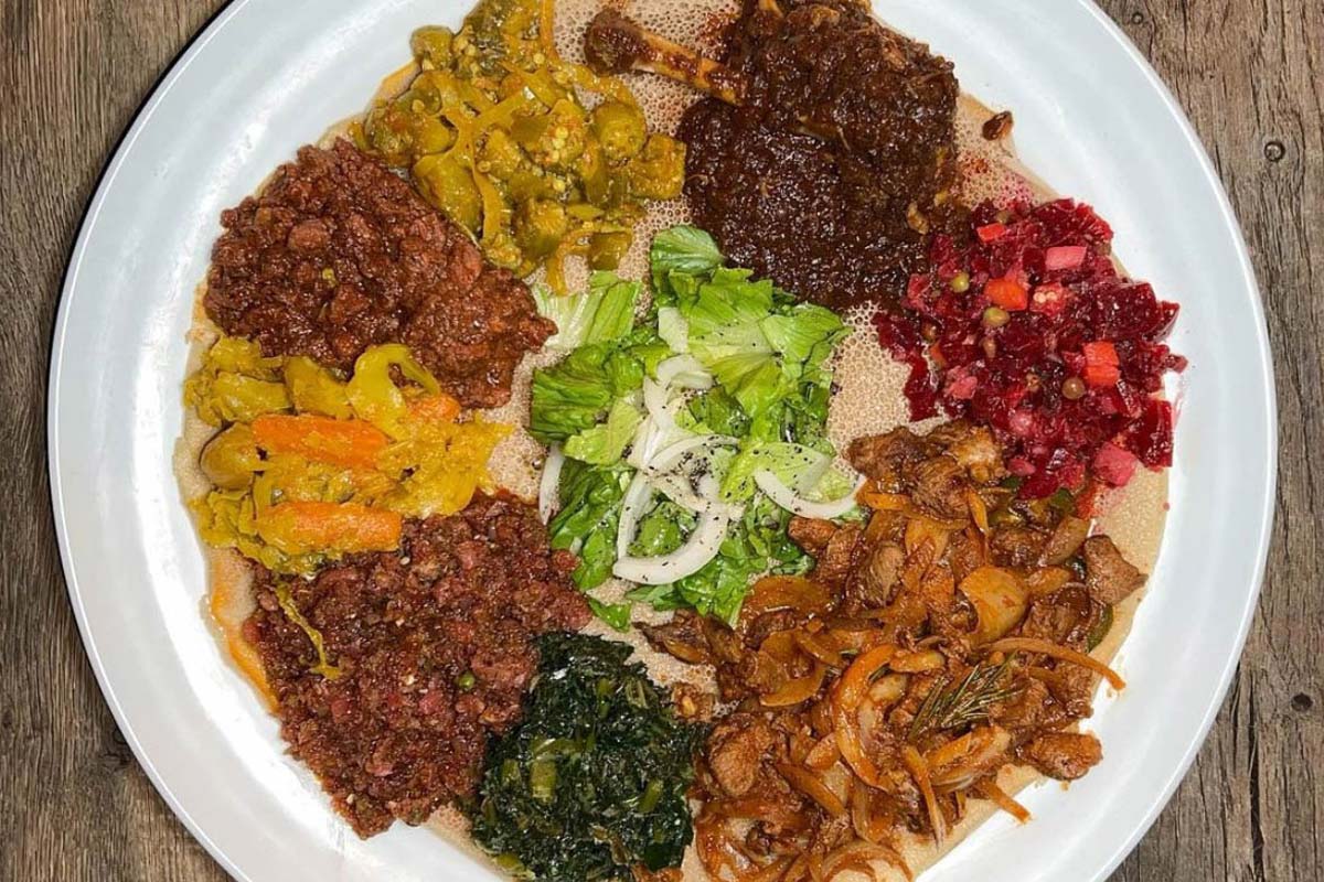 Ground beef and veggies on injera platter