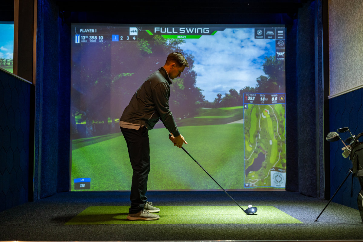 a person playing golf on a stage