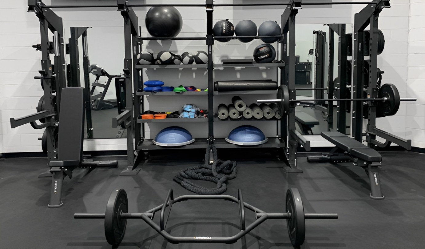 Interior, various fitness equipment, benches, and machines