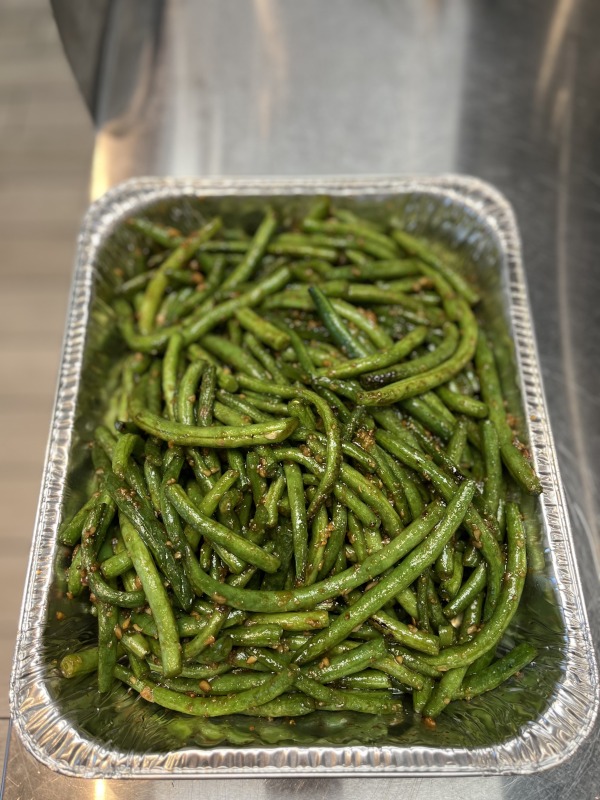 Grilled asparagus in a large serving container