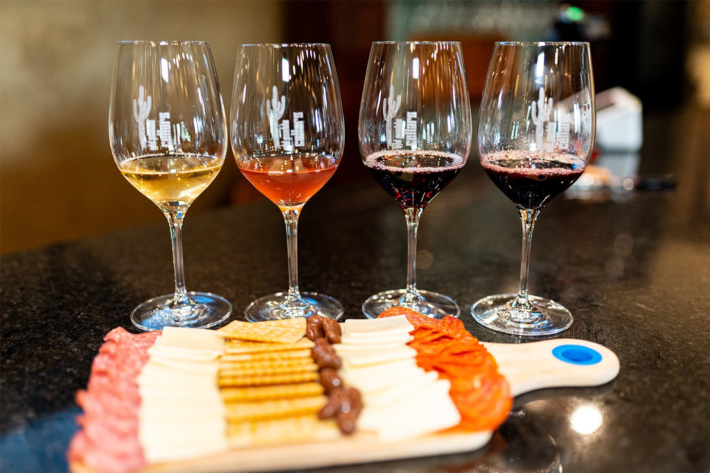 Wine served in glasses with charcuterie and cheese board in front