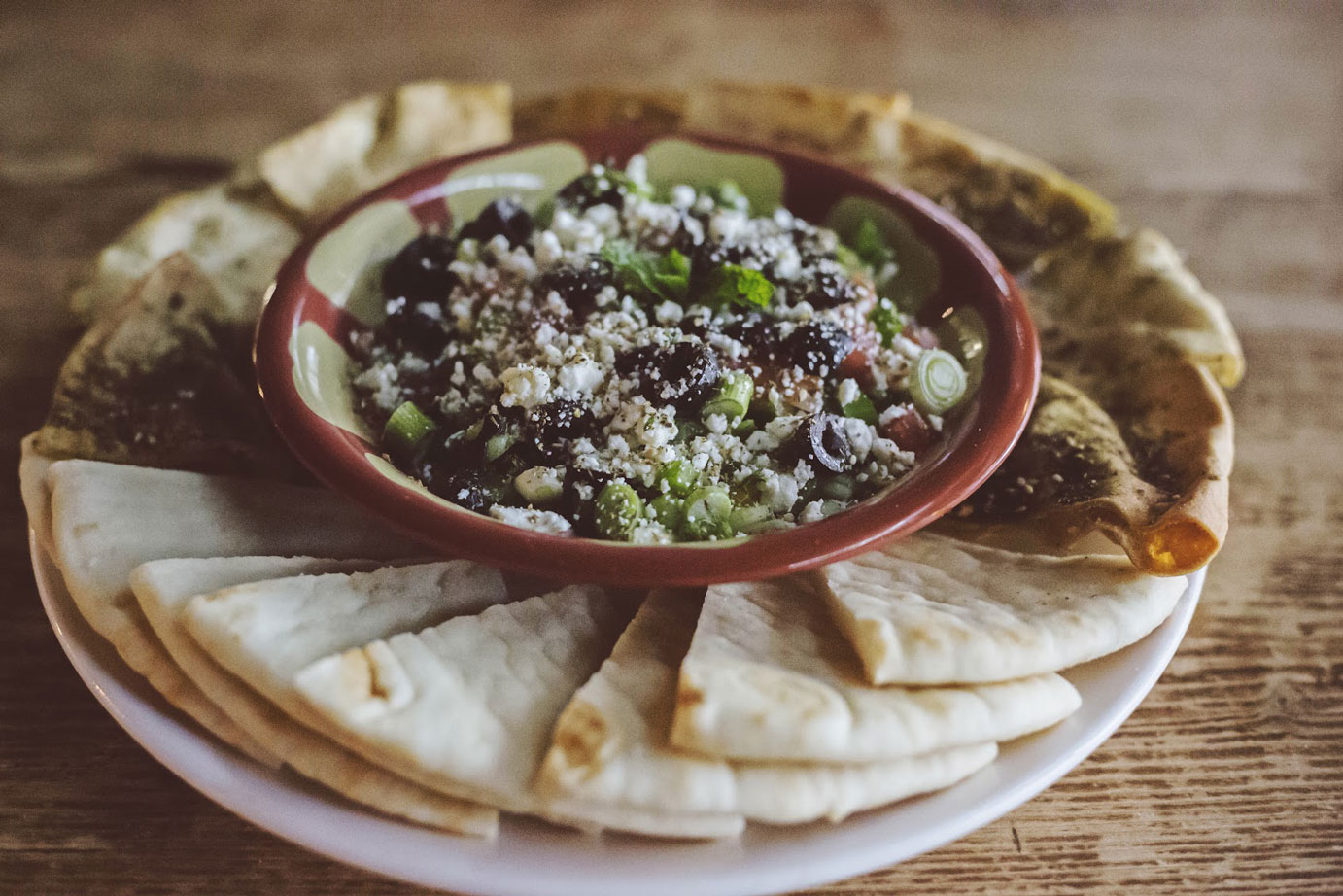 Lebanese eight layer dip served with pita bread  