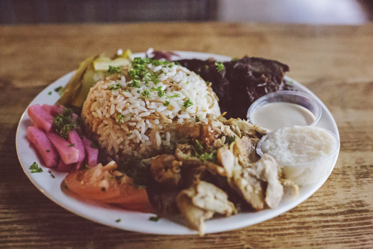 Plate with meats, rice, pickles and sauces