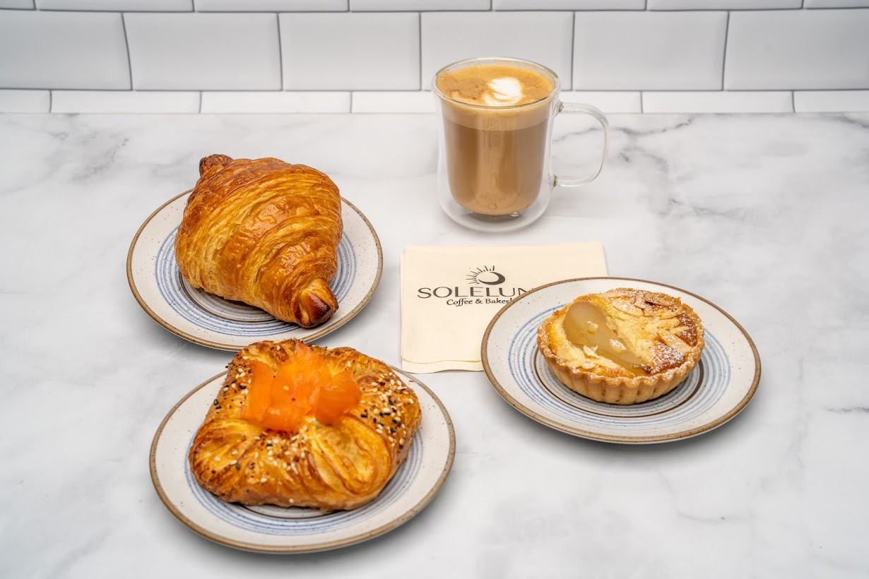 Croissant, everything bagel Danish pastry and pear almond tart with coffee