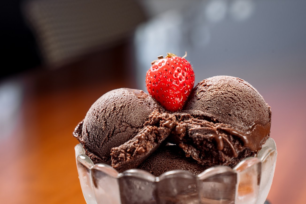 Close up of chocolate ice cream with a strawberry on top