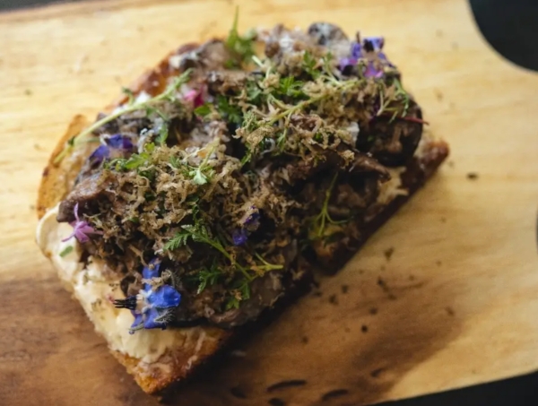 Toast adorned with herbs and delicate flowers