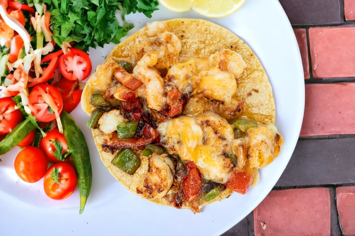 Shrimp taco, with melted cheese and mixed vegetables