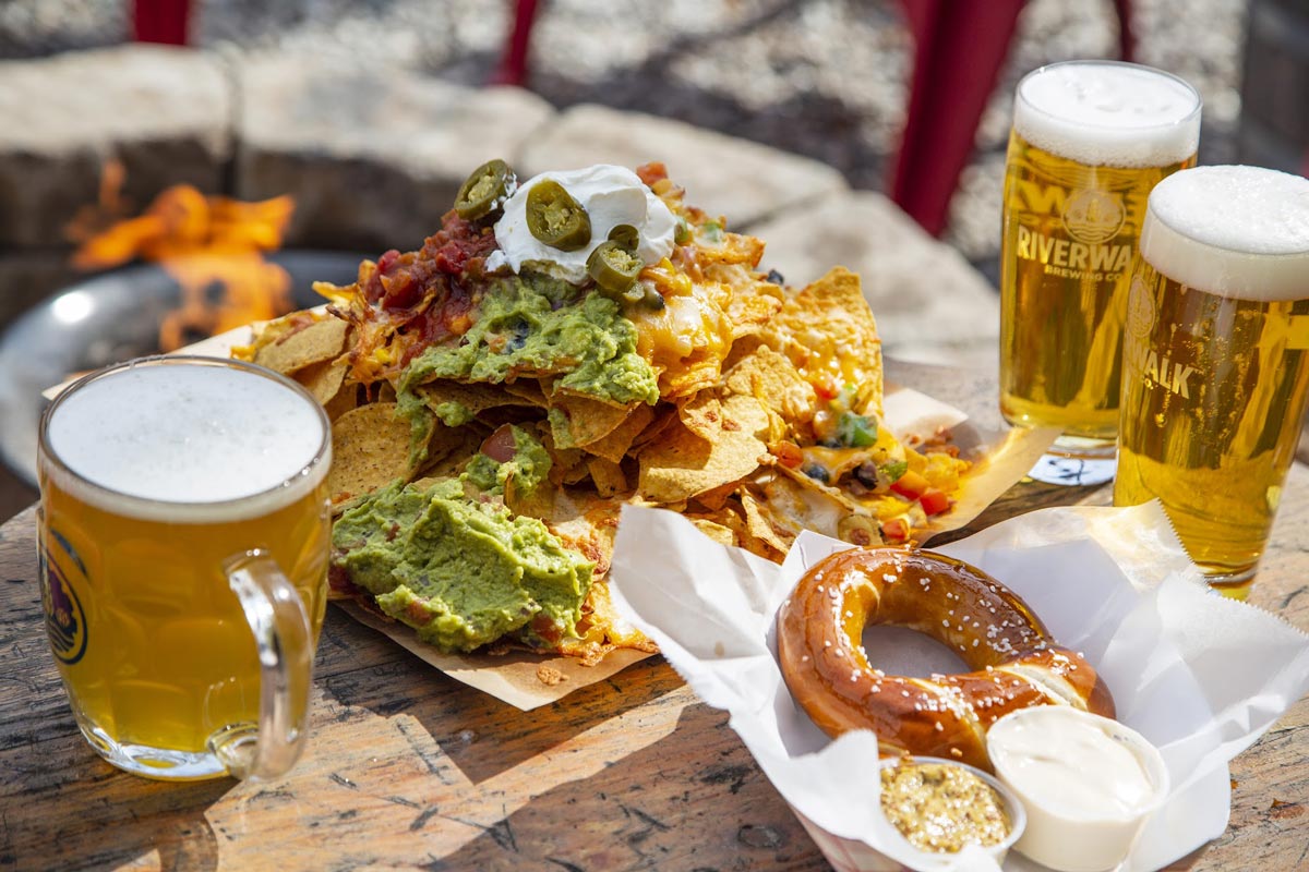 Nachos served with dressing, pretzels and beer