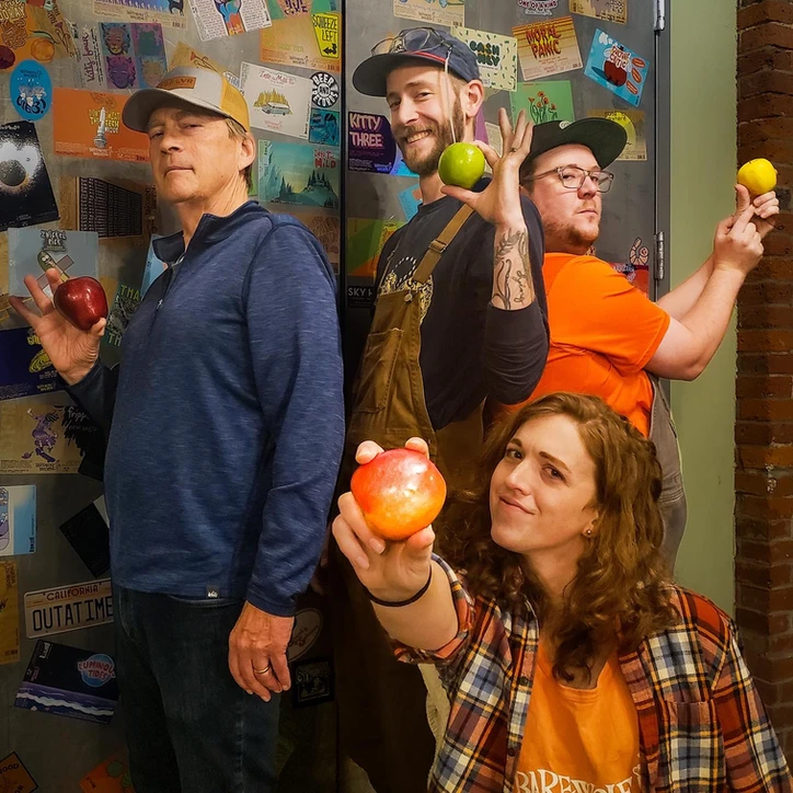  Team striking a pose with apples in hands