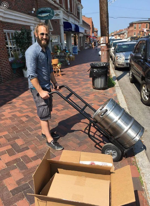 Brony  carrying a beer keg on a keg trolley