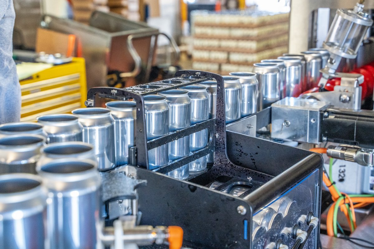 A machine is making aluminum cans in a factory