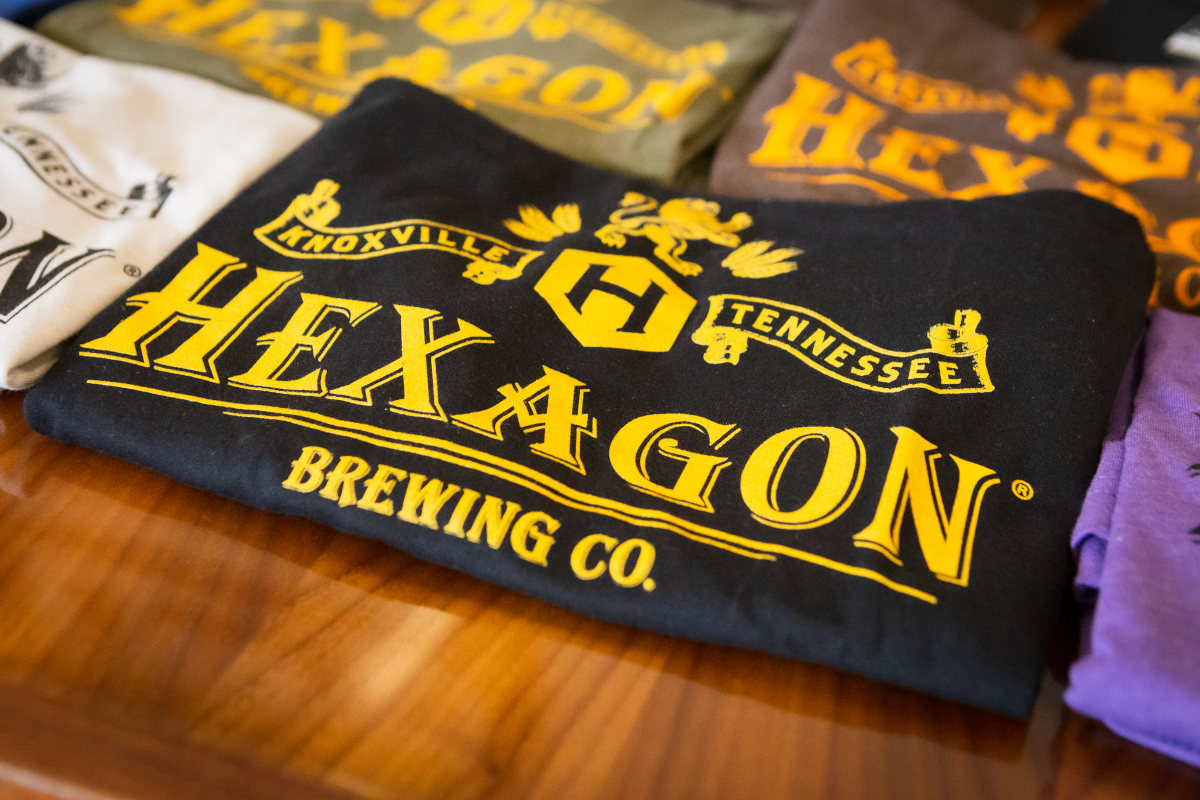 Folded black shirt with a yellow brewery logo