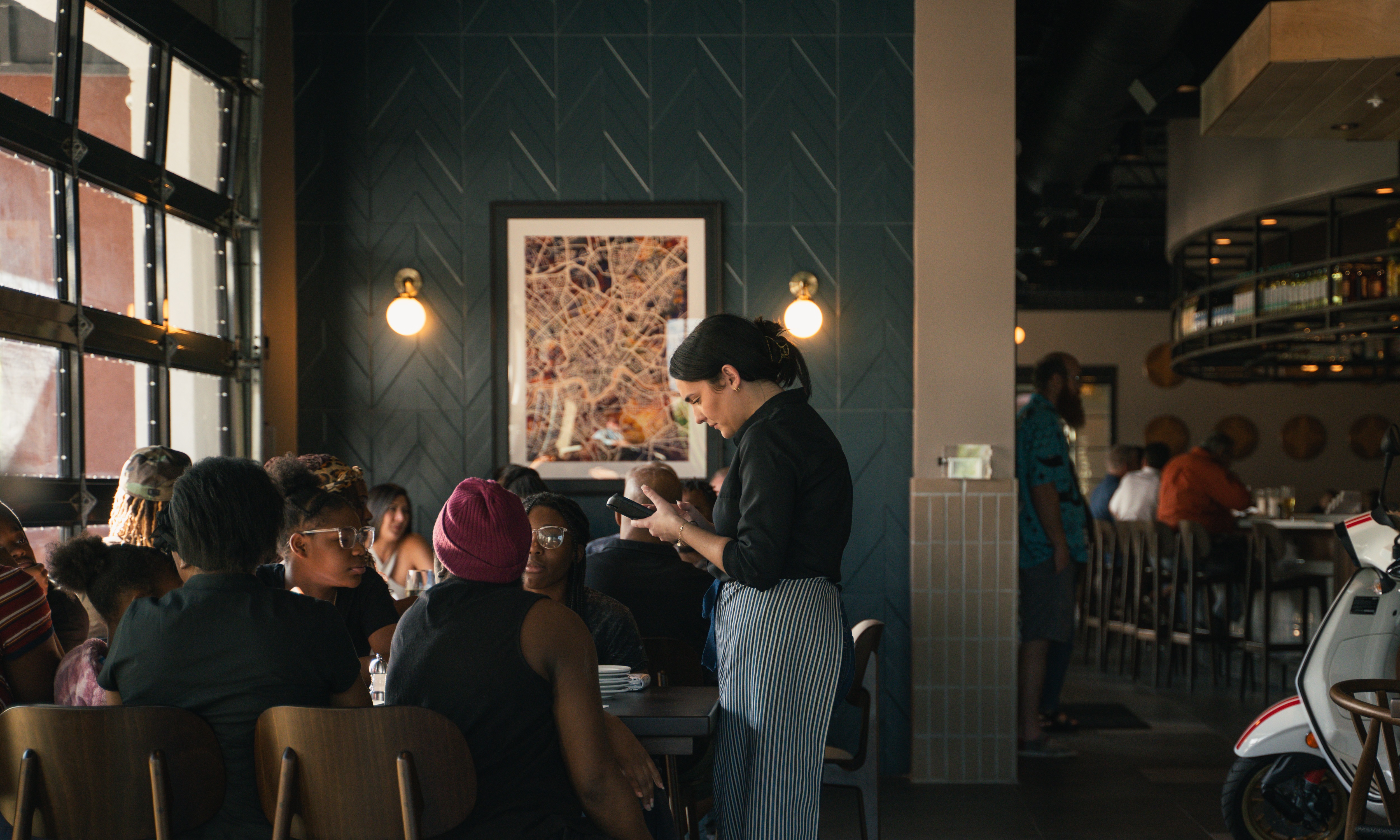 Bartender serving a group of people