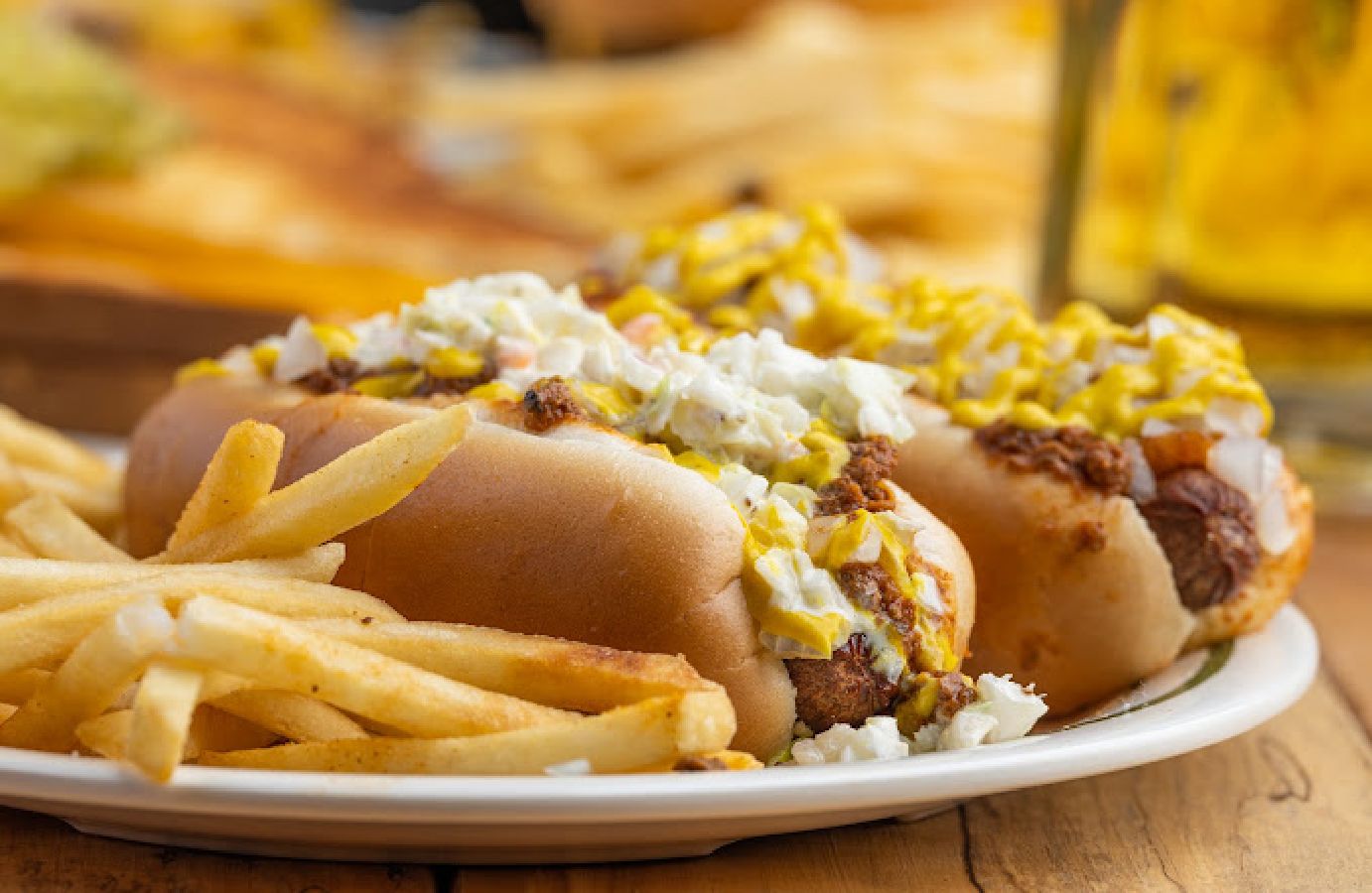 Chili & slaw dogs on a plate side view
