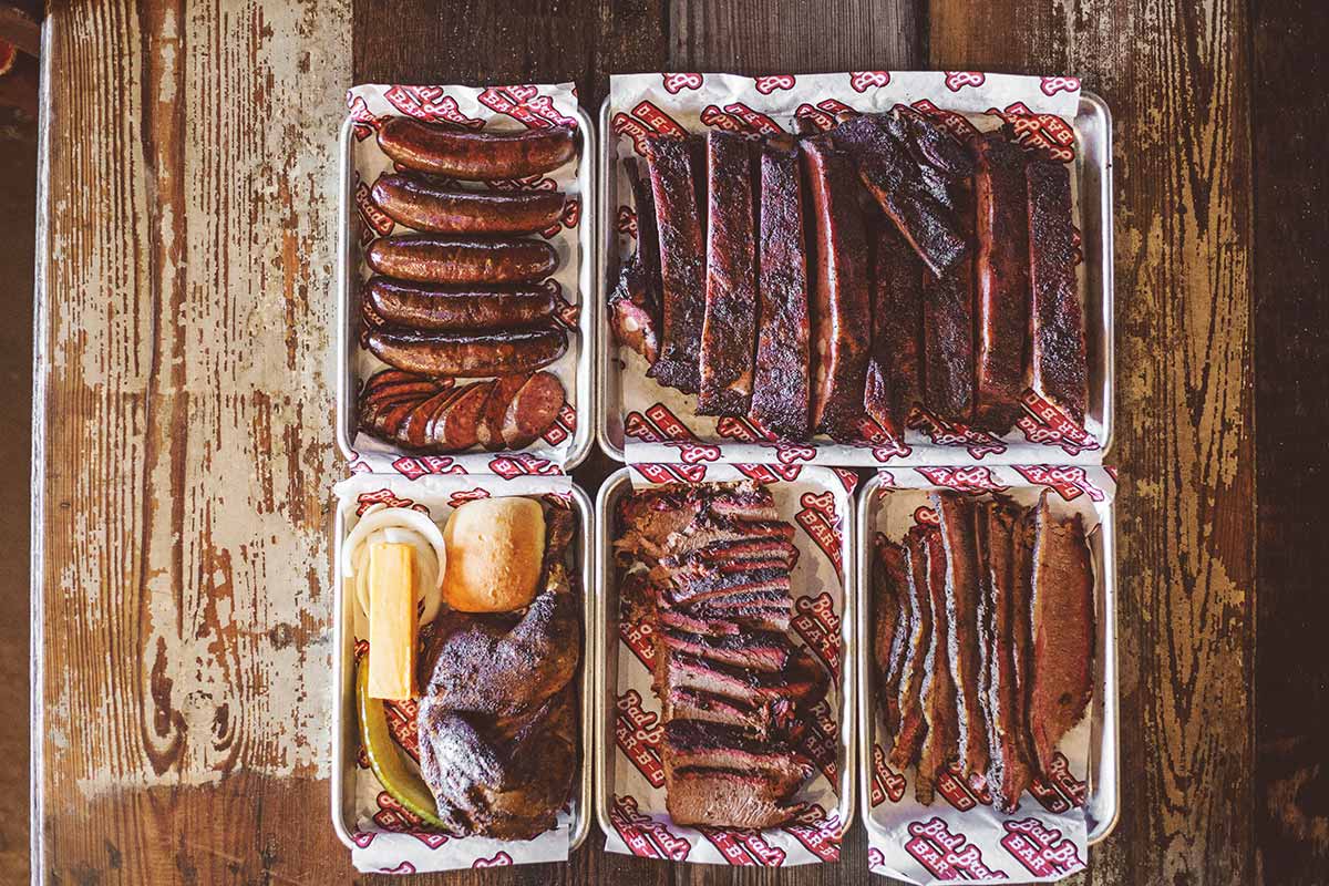 A group shot of various served meats on trays