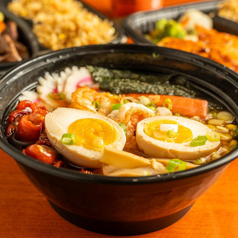 A bowl filled with colorful vegetables and noodles