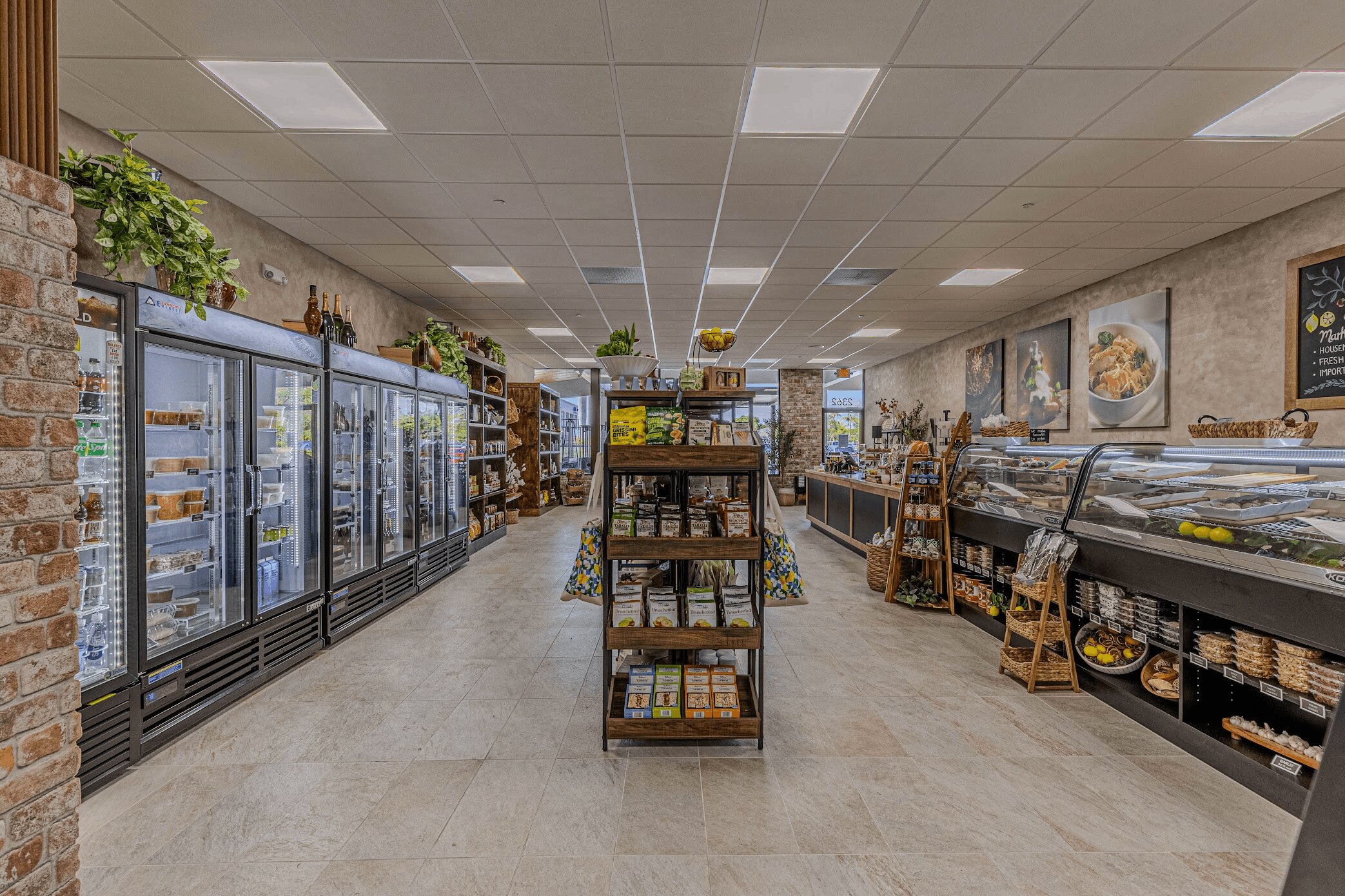 Aisle view of the market with refrigerated cases along the wall